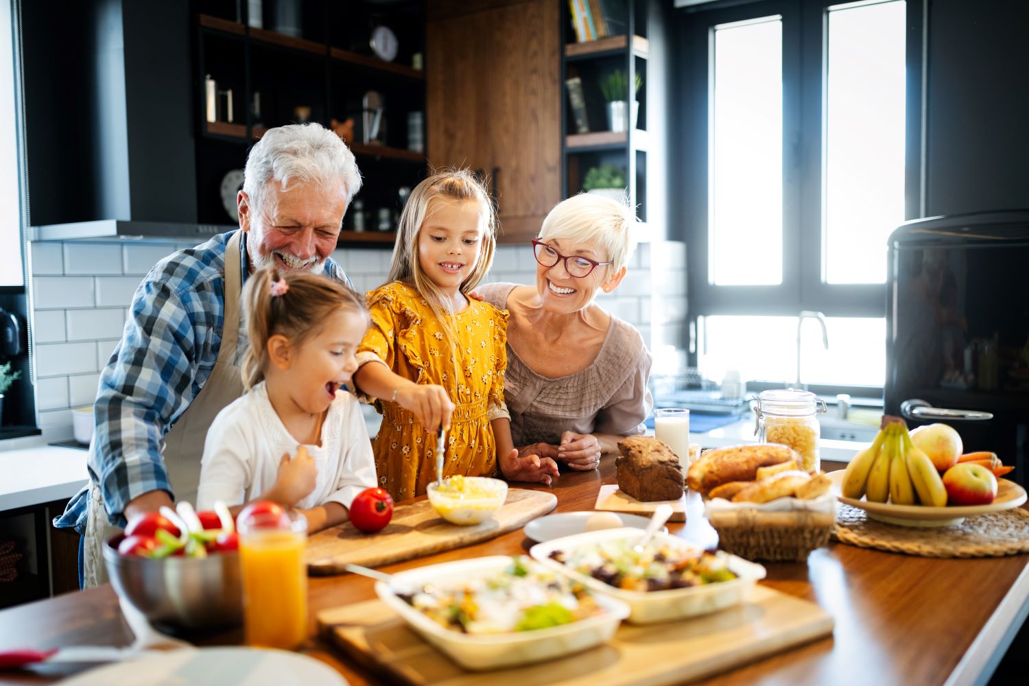 Grandparents with grandchildren making breakfast 