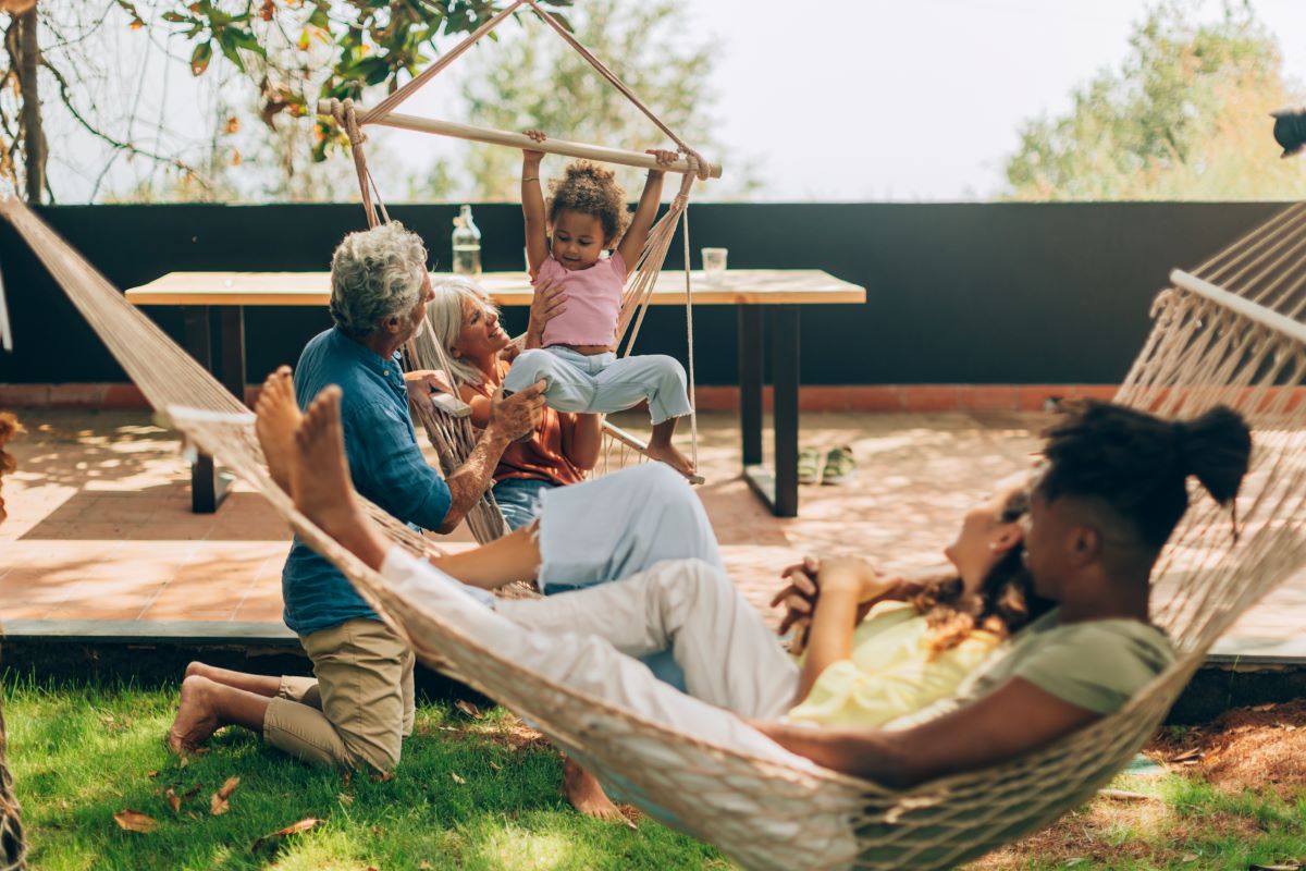Multigenerational family relaxing outdoors with hammocks